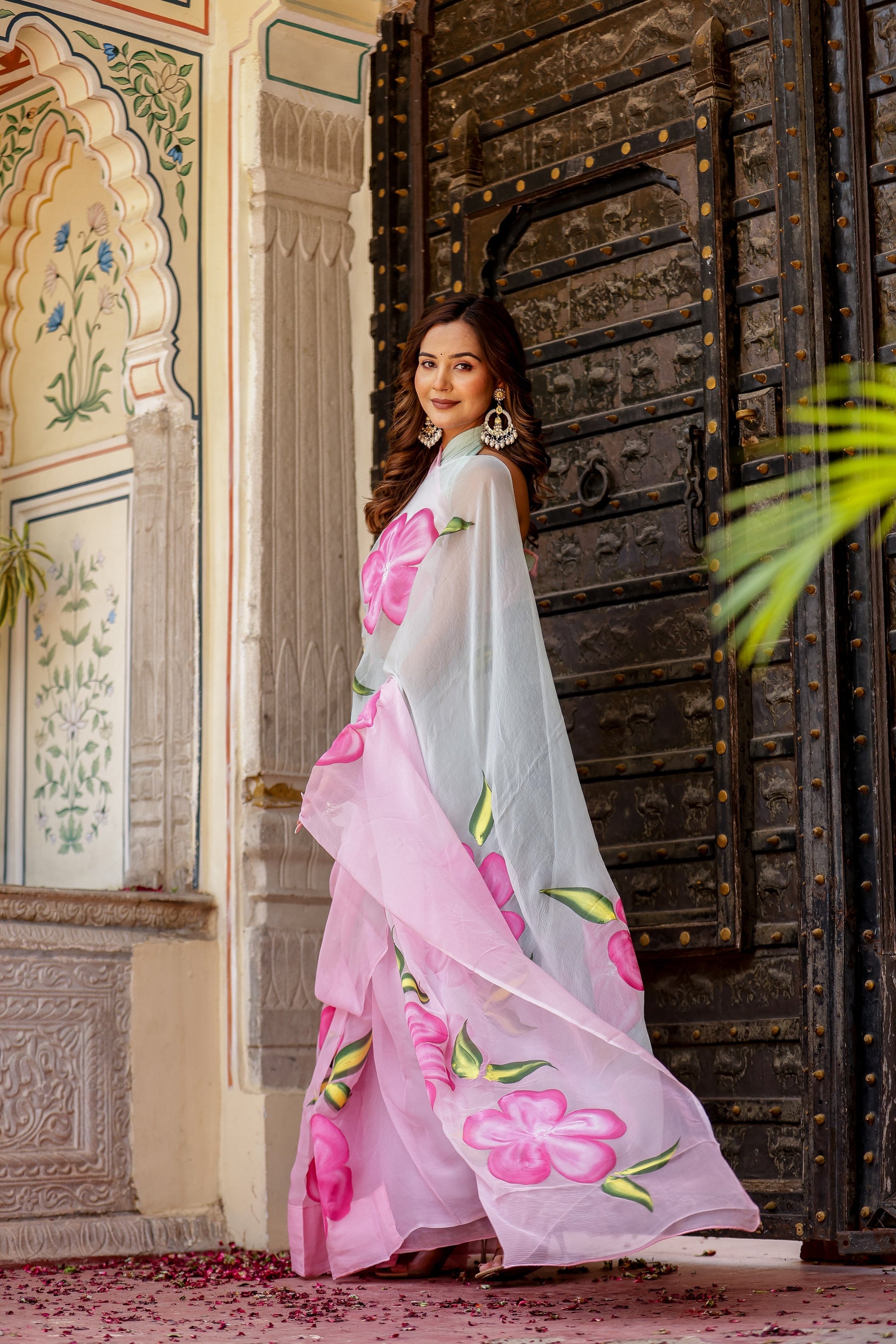 Stylish woman in a pink and grey trendy chiffon saree for elegant occasions. Buy trendy chiffon saree.