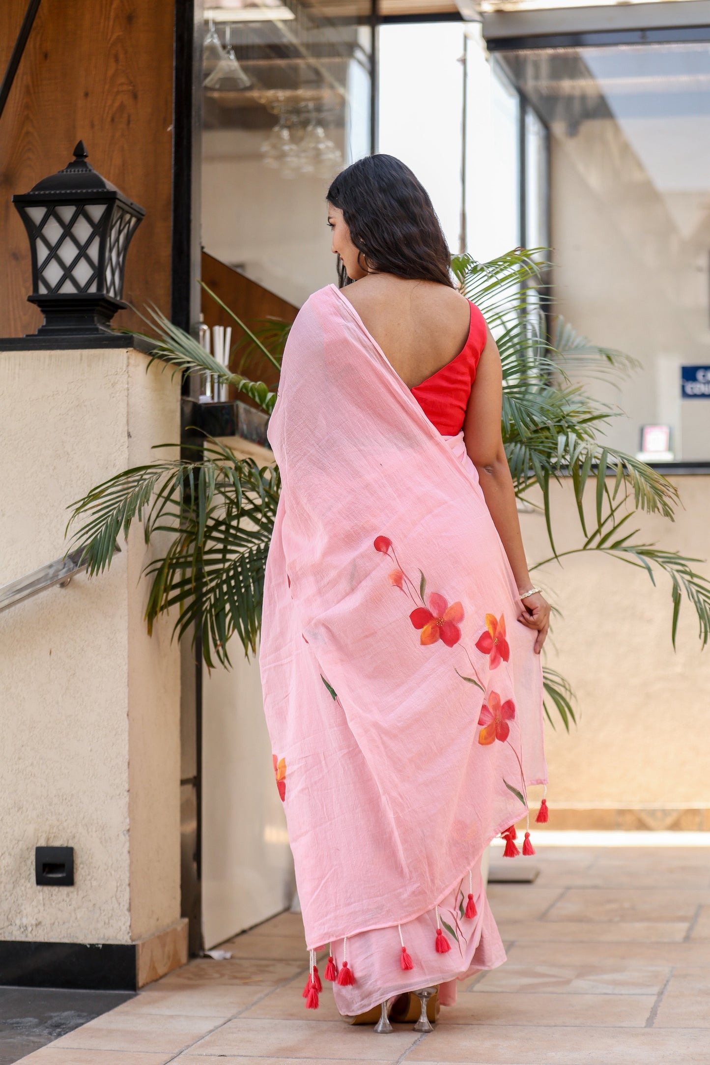 Elegant pink malmal saree with floral embroidery and tassels, perfect to buy trendy malmal saree