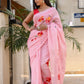 Elegant pink malmal saree with floral prints and tassels, perfect for modern occasions to buy trendy malmal saree.