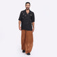Man wearing caramel wide leg pants paired with a stylish black shirt for casual outings