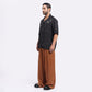 Stylera caramel wide leg pants shown on a model paired with a short black shirt