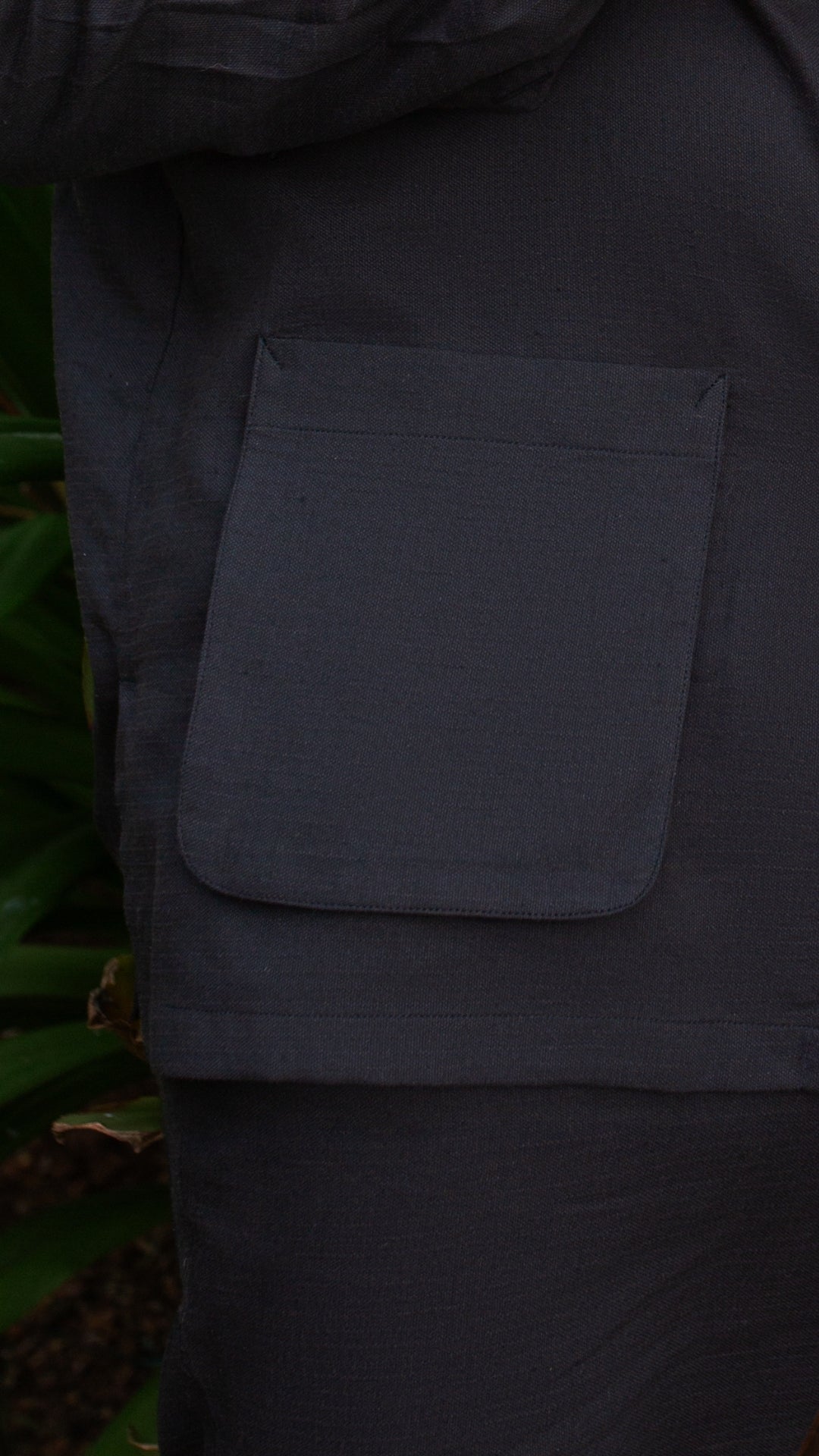 Close-up of casual black outfits for men showing a stylish pocket design on a shirt