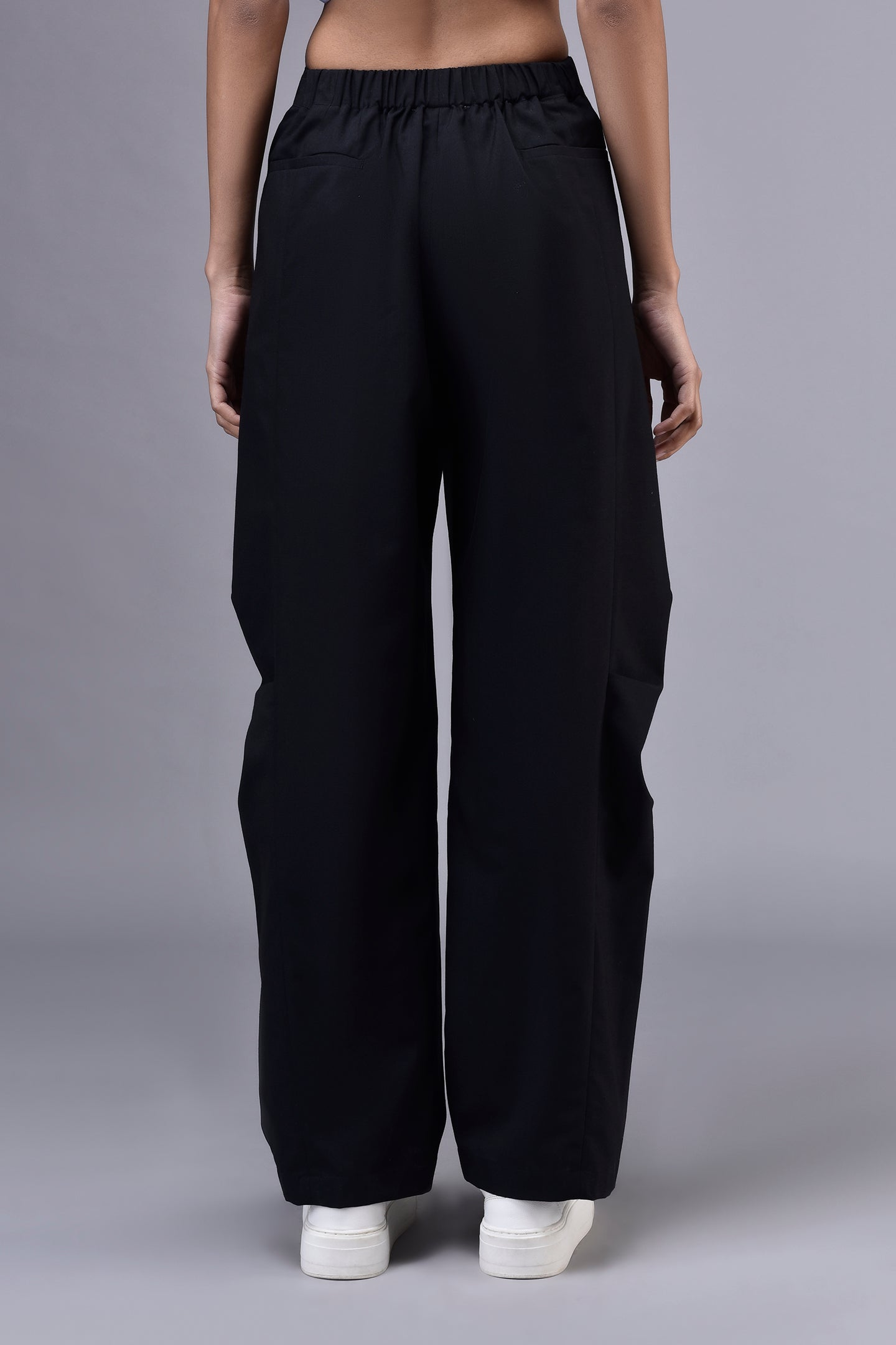 Back view of Stylera casual black trousers for women with elastic waistband wide leg and side pocket