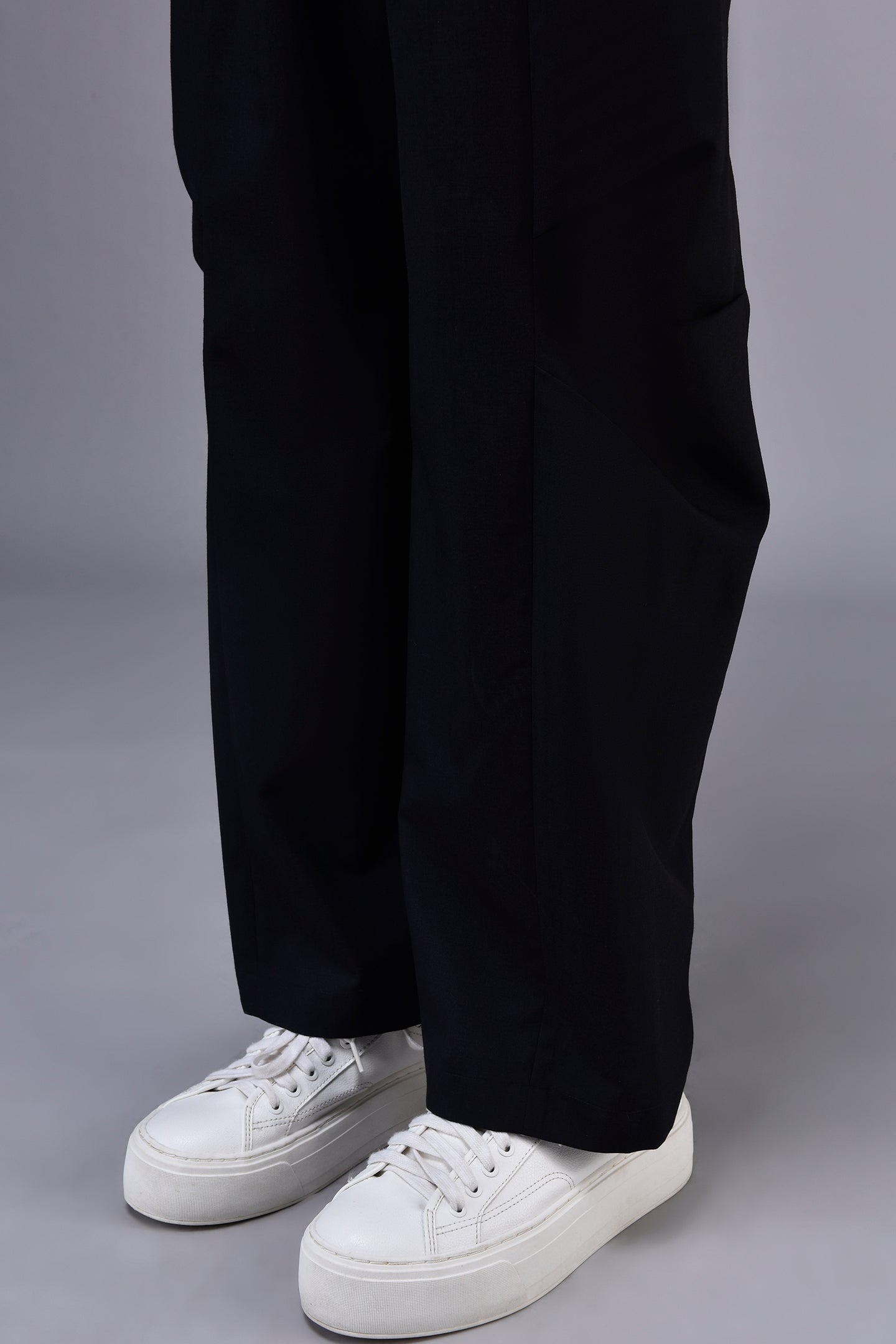 Stylera casual black trousers for women straight wide leg full length shown with white platform sneakers