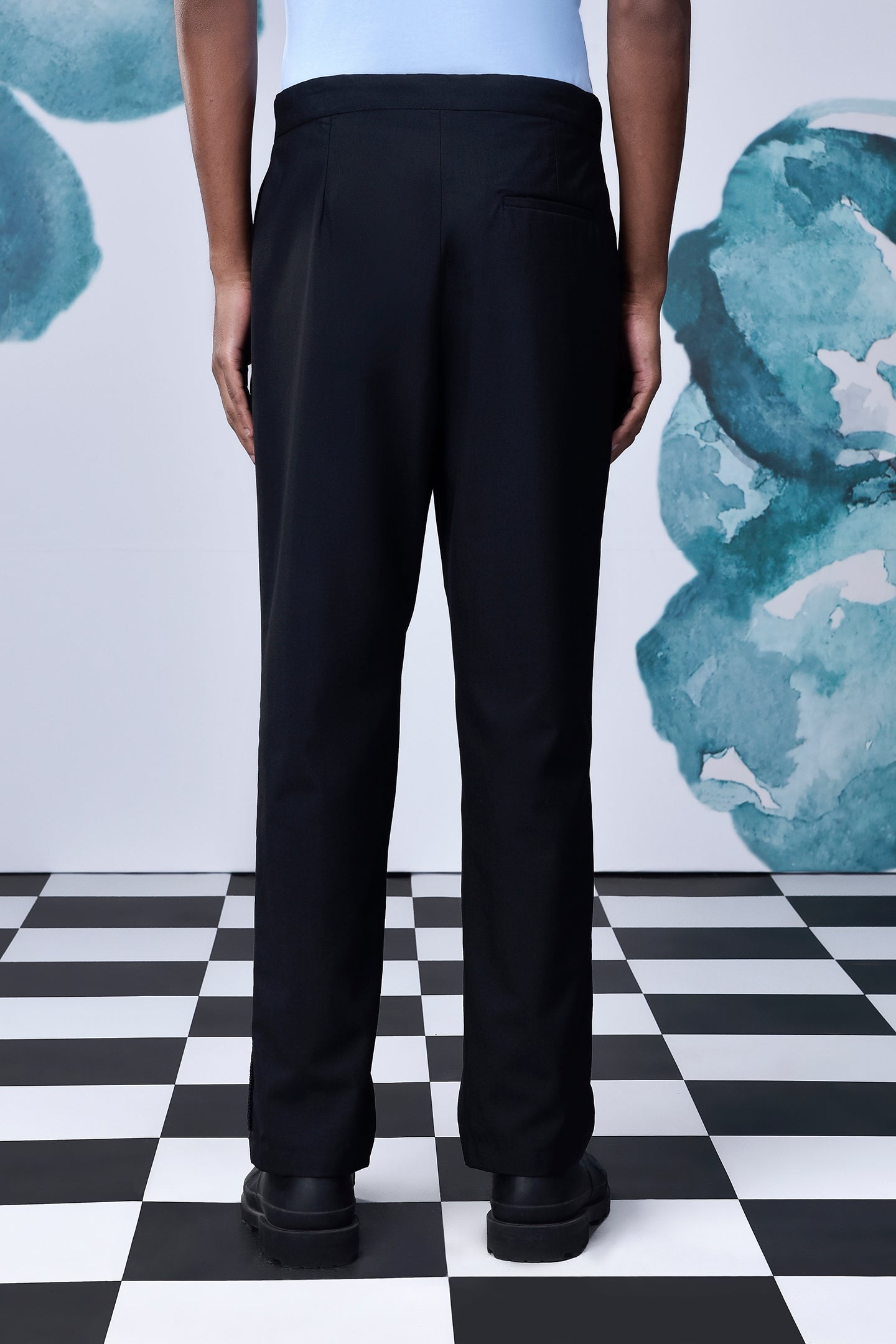 Back view of casual black wool trousers by Stylera worn with black shoes