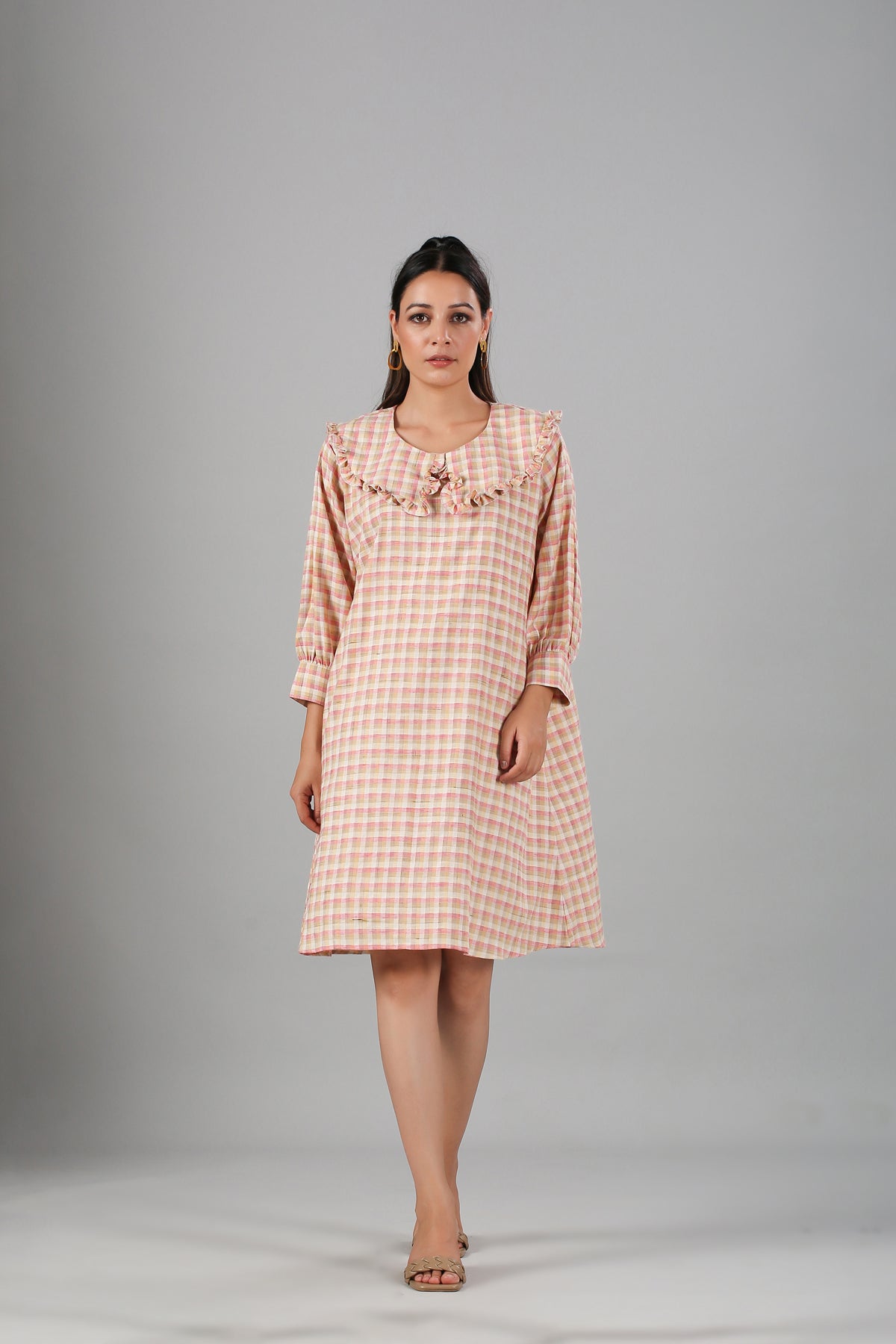 Casual checkered dress for women in peach with ruffled neckline and long sleeves by Stylera