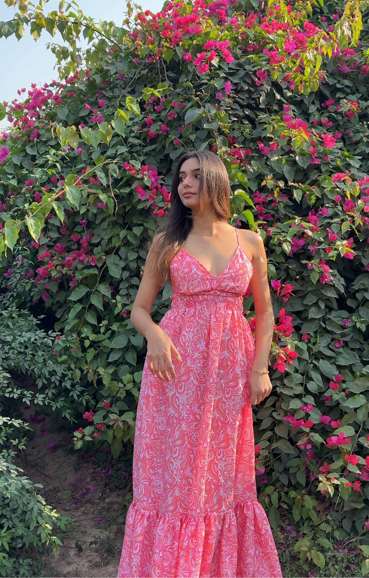 Model wearing Stylera pink paisley casual floral maxi dress with V neckline and ruffle hem in garden