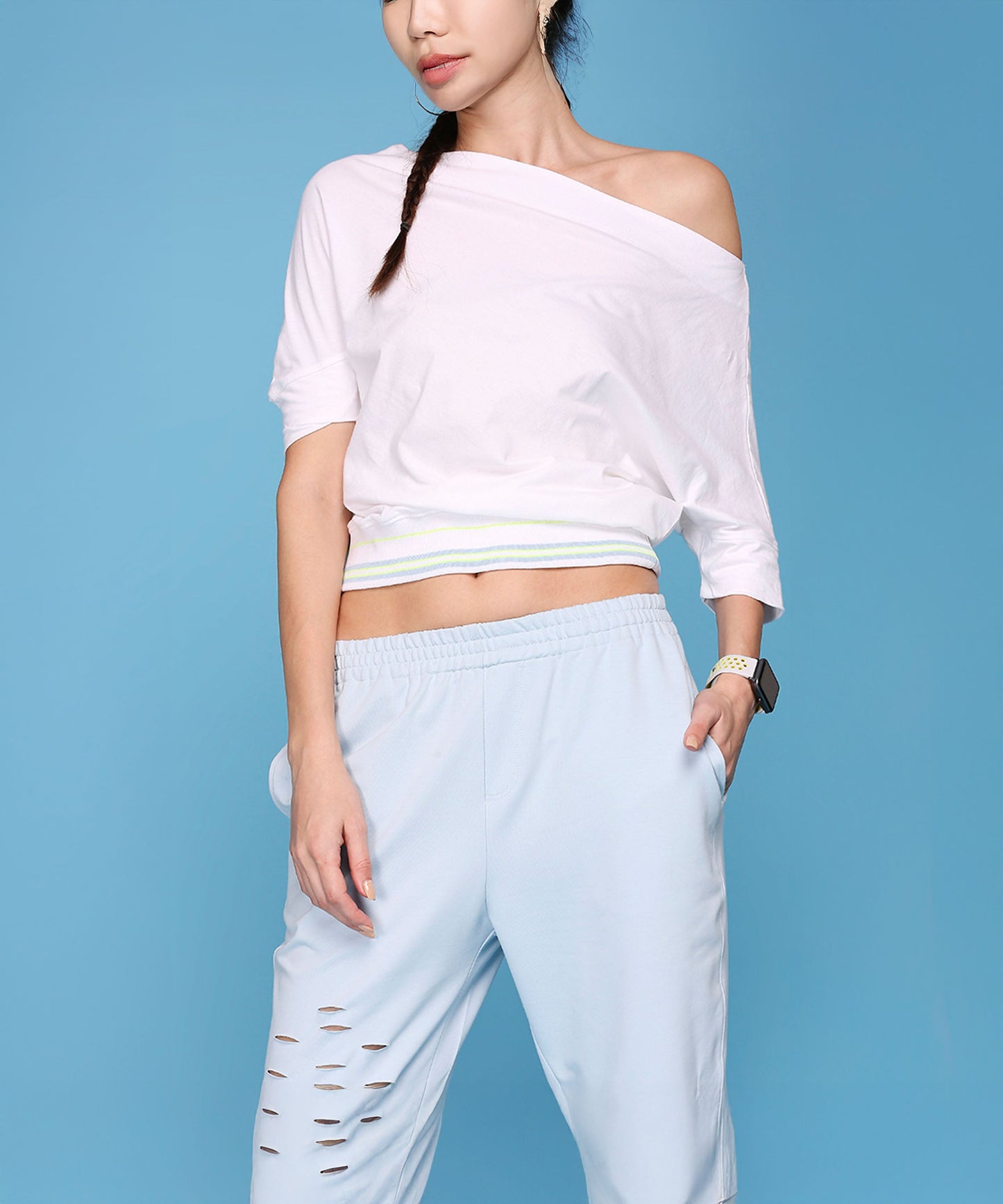 Casual off shoulder lounge set featuring a white top and light blue pants with stylish cutouts