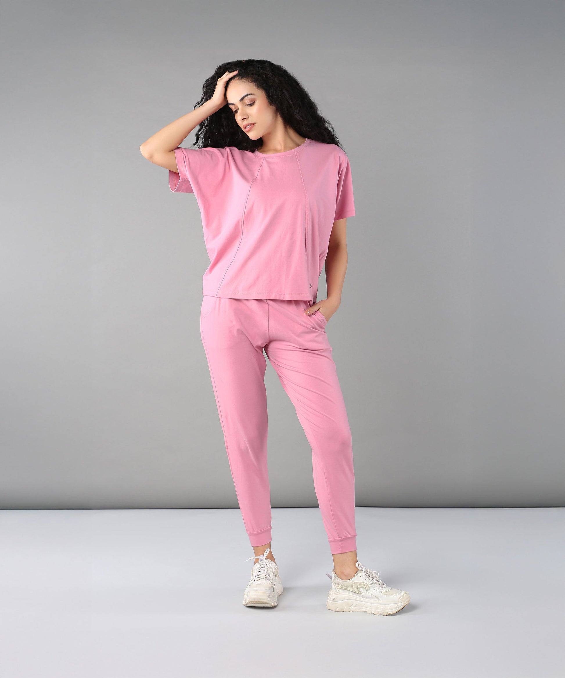 Trendy casual pink lounge wear for women featuring a relaxed fit top and tapered pants