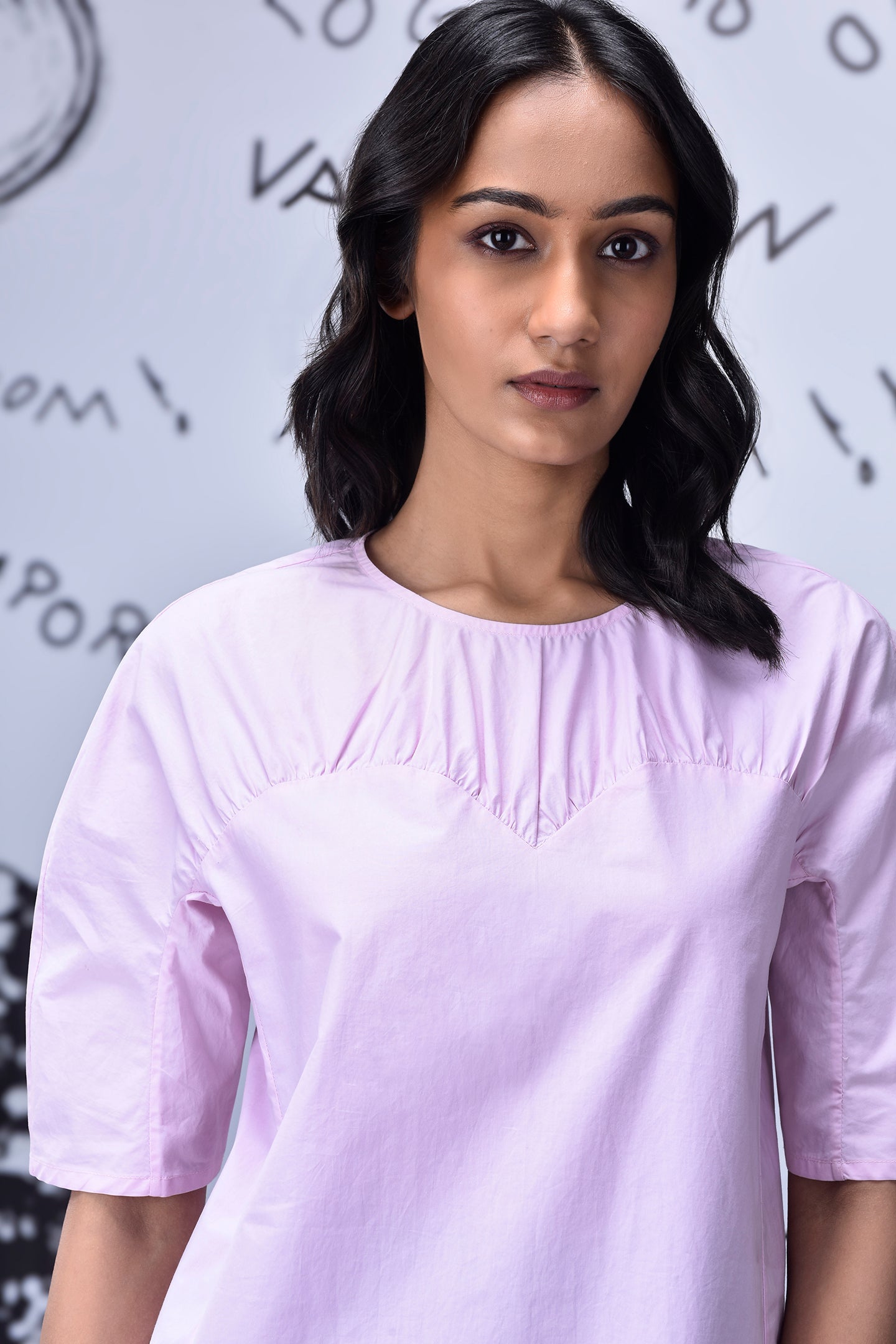 Stylera casual pink top for women with round neckline gathered yoke and elbow sleeves on model