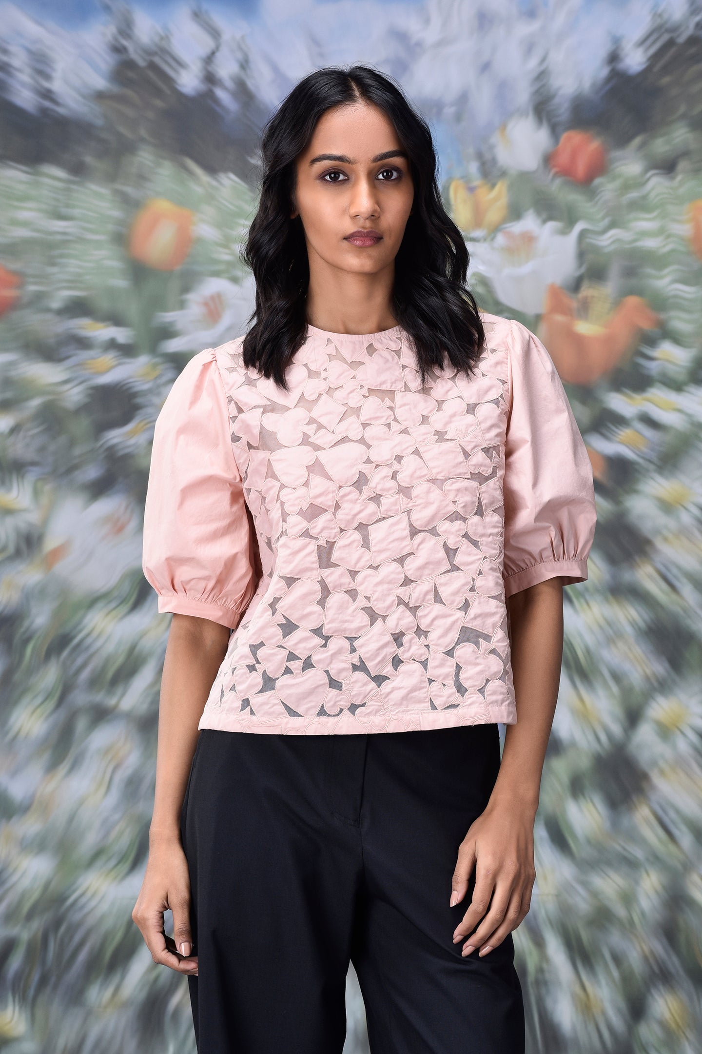 casual semi fit top for women light pink floral lace front with puff sleeves and round neckline modeled with black pants