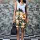 Stylera casual sleeveless dress floral printed meadow design model holding black bag