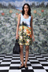 Stylera casual sleeveless dress floral printed meadow design model holding black bag