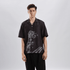 Stylera black short sleeve button shirt with classical statue graphic worn by model casual statement shirts for men