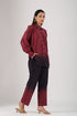 Model wearing a casual two-piece ombre outfit in burgundy and dark purple tones, featuring a button-up shirt and matching pants.