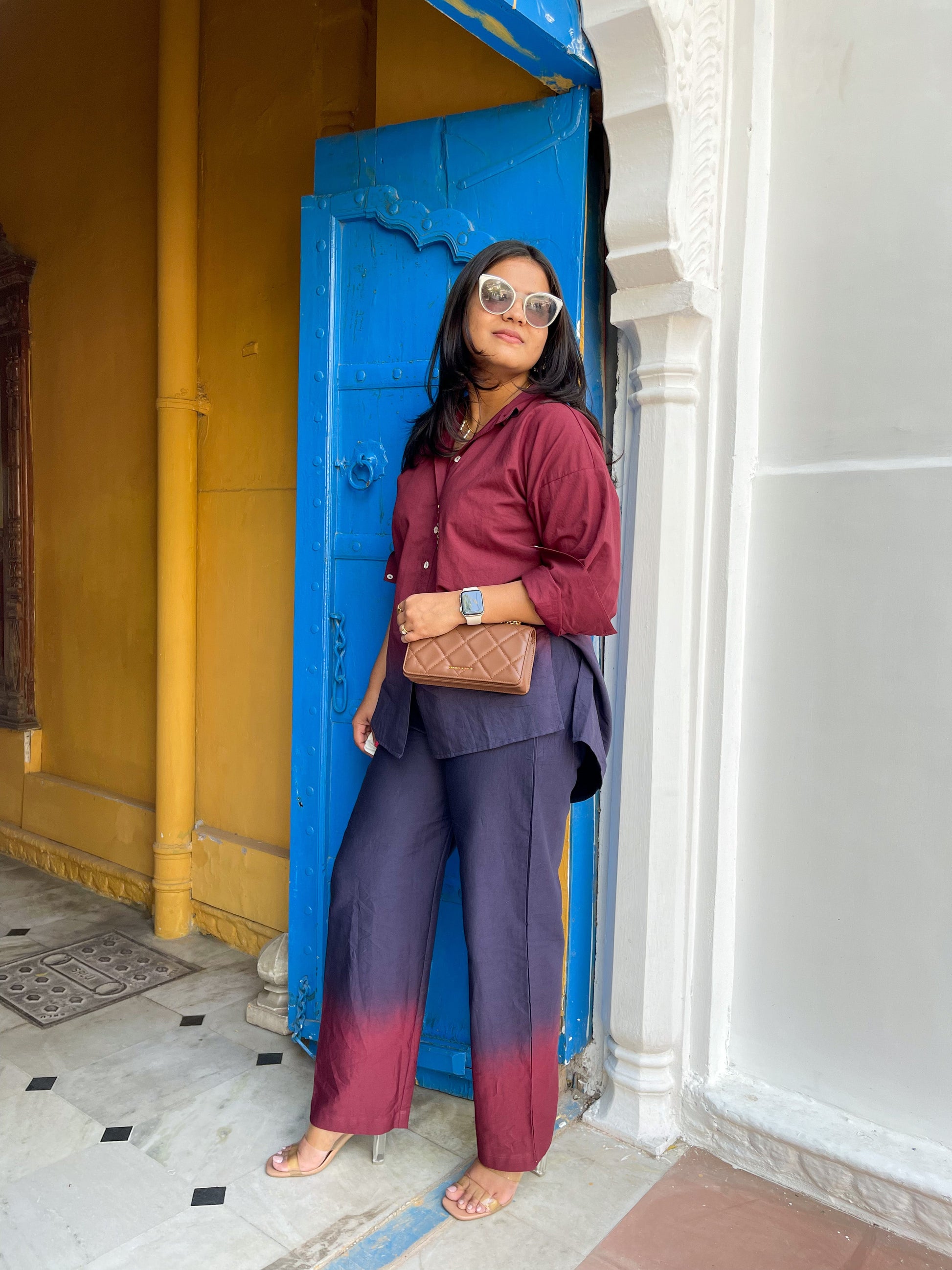 Stylish woman wearing a casual two-piece ombre outfit with maroon and purple colors, paired with sunglasses
