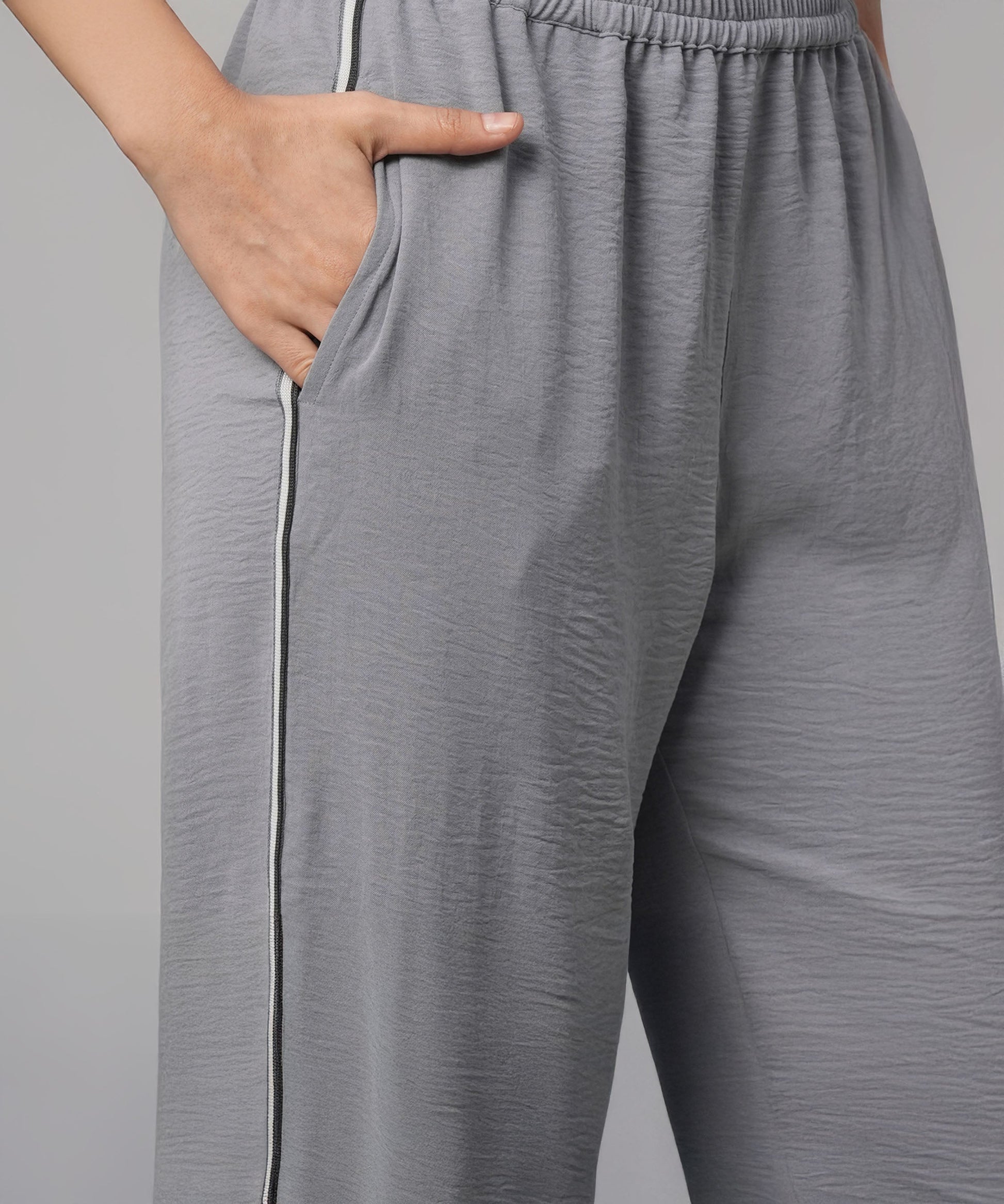 Casual two piece outfit for women featuring gray pants with side pockets and a comfortable fit