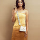 Champagne beige mini sling bag styled with a strap, perfect for casual outings and elegant occasions