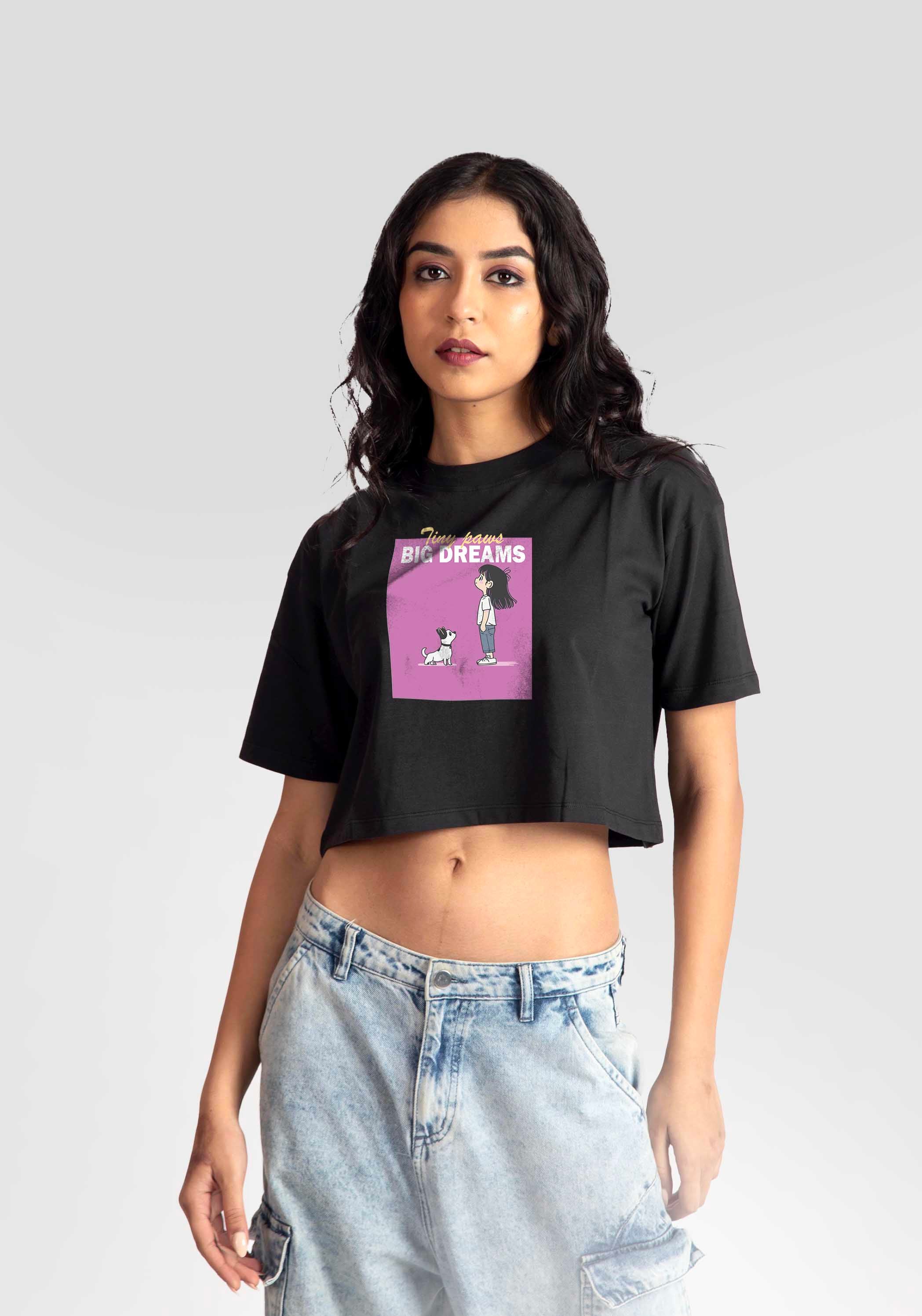 Woman wearing Stylera charcoal black oversized crop top with graphic print and light wash jeans