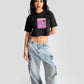 Charcoal black oversized crop top by Stylera featuring a pink graphic print worn with light blue wide-leg jeans