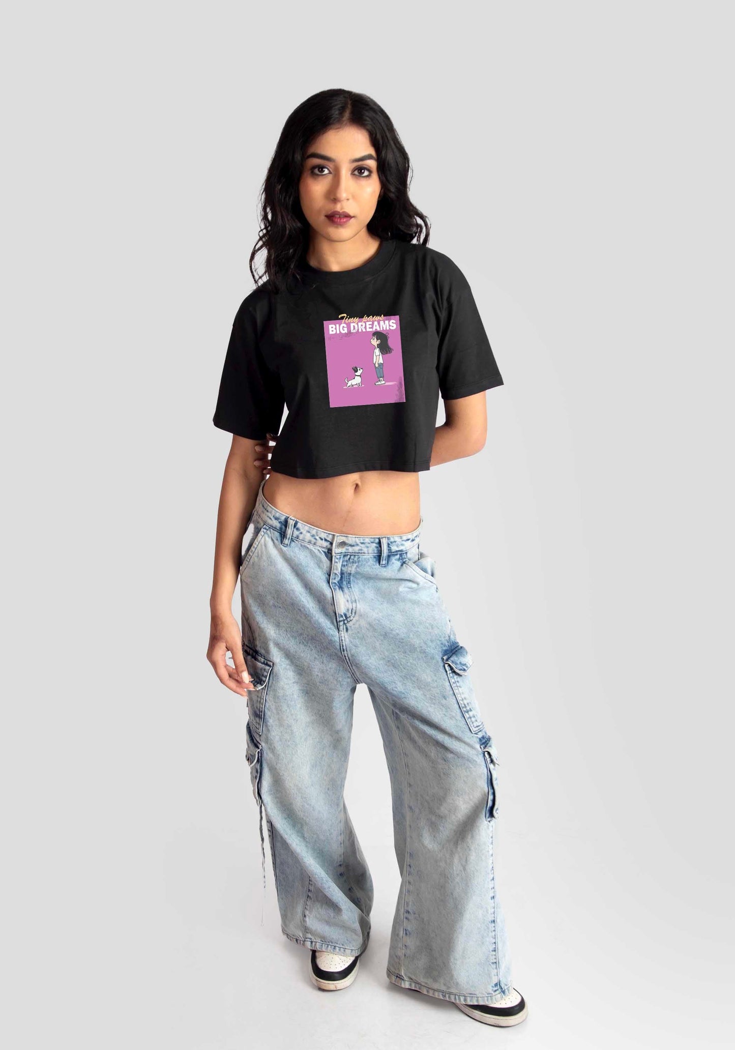 Charcoal black oversized crop top by Stylera featuring a pink graphic print worn with light blue wide-leg jeans