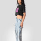 Woman wearing charcoal black oversized crop top paired with light blue cargo jeans and sneakers