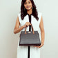 Charcoal caramel handbag by Stylera held by a woman in a stylish outfit
