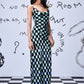 Model in Stylera chess board cowl neck dress black and mint check floor length with straps