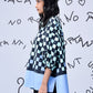 Woman side profile wearing Stylera chess board print oversized shirt with blue hem