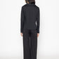 Back view of a chic black blouse for women by Stylera paired with matching black wide-leg pants
