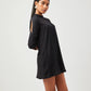 Stylera chic little black dress with long sleeves and high neckline on model