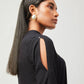 Stylera chic little black dress with open shoulder design worn by model with gold earrings