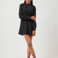 Stylera chic little black dress with long sleeves and high neckline worn by model