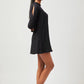 Stylera chic little black dress with long sleeves and cutout details worn with black flats