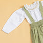 Children's pinafore dress with suspenders in green, paired with a white ruffled blouse for playful outfits