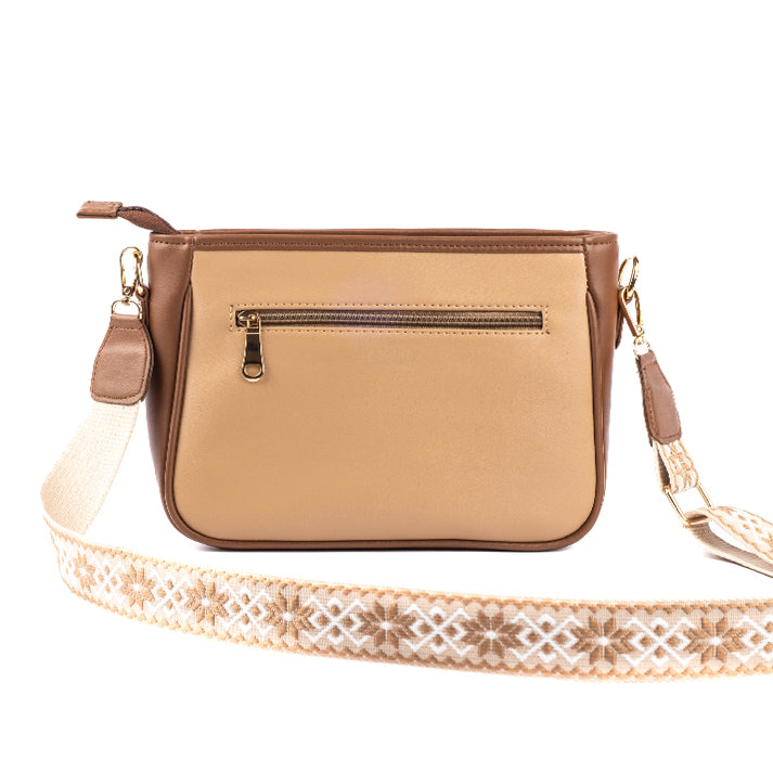 Cinnamon cocoa sling bag with stylish design and decorative strap, perfect for casual outings