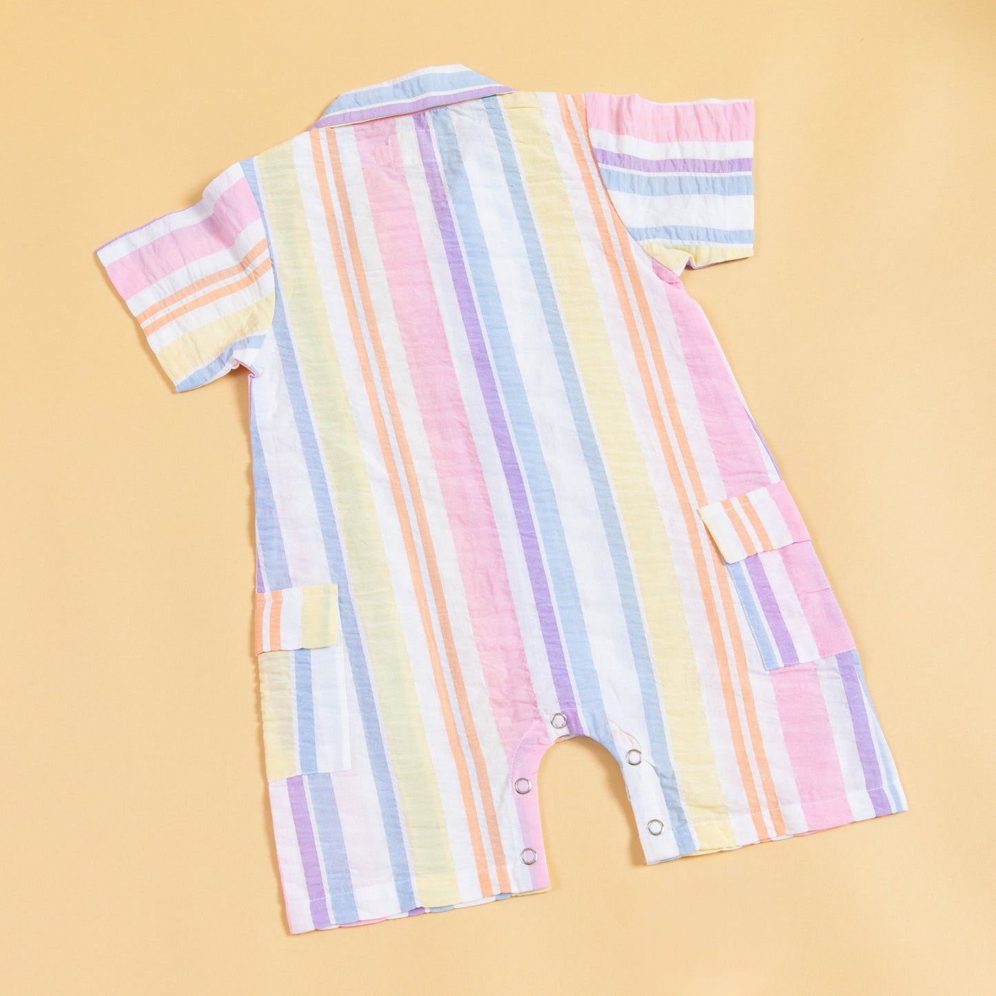 Colorful summer playsuit by Stylera with a striped design and easy snap closure