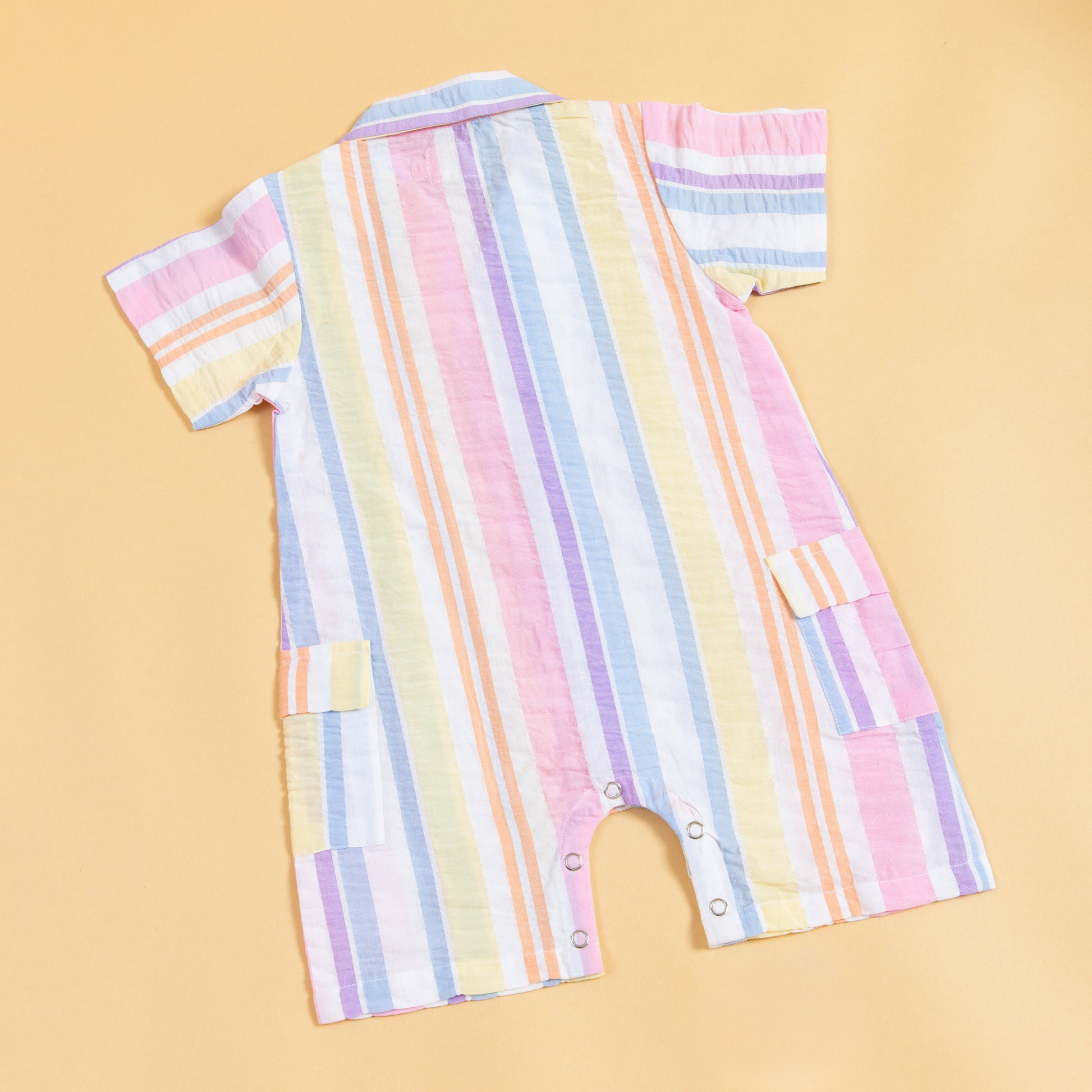 Colorful summer playsuit by Stylera with a striped design and easy snap closure
