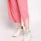 Woman wearing a comfortable summer co-ord set with pink pants and stylish white sneakers