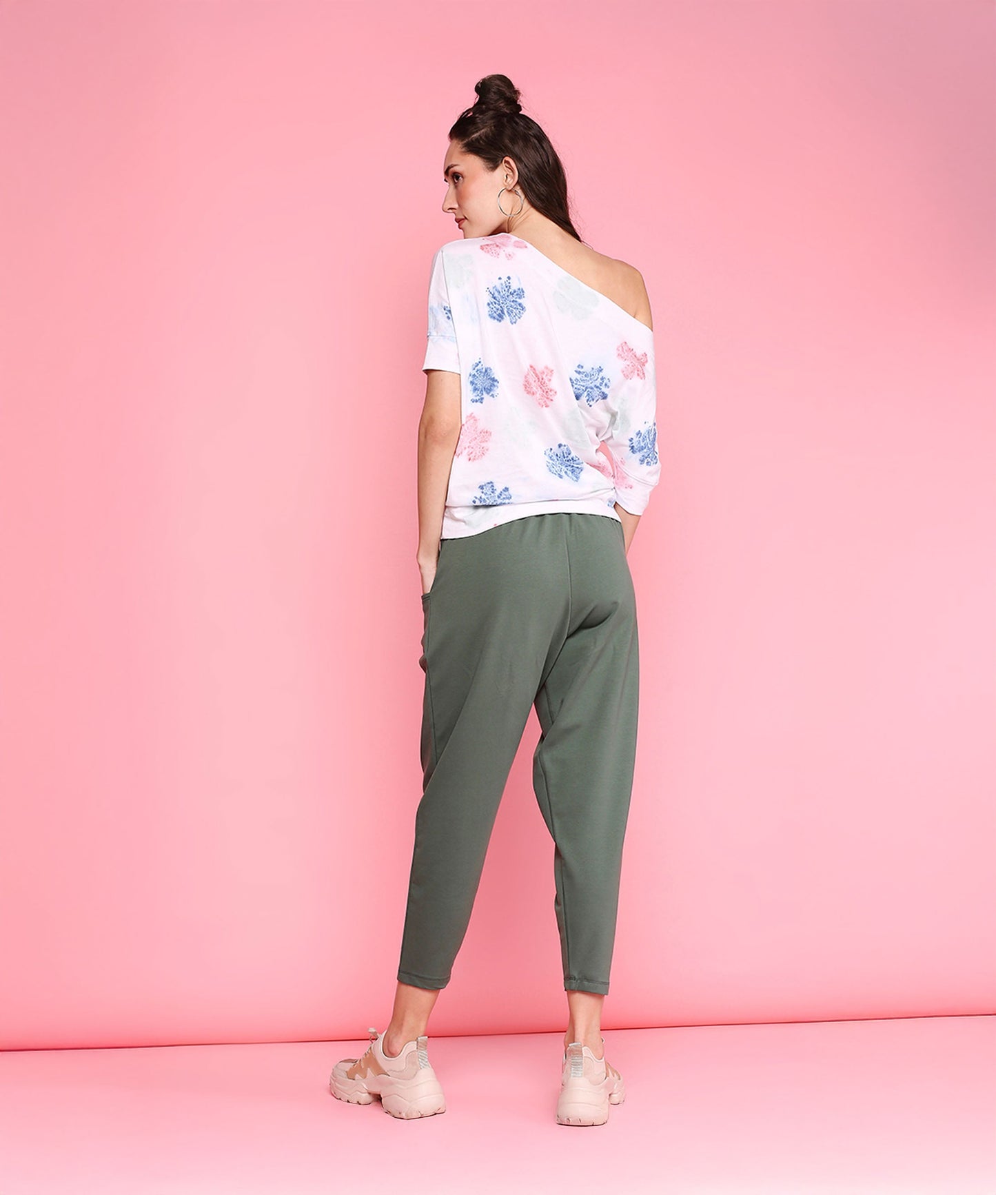 Model wearing comfortable yoga pants with pockets in olive green paired with a stylish top