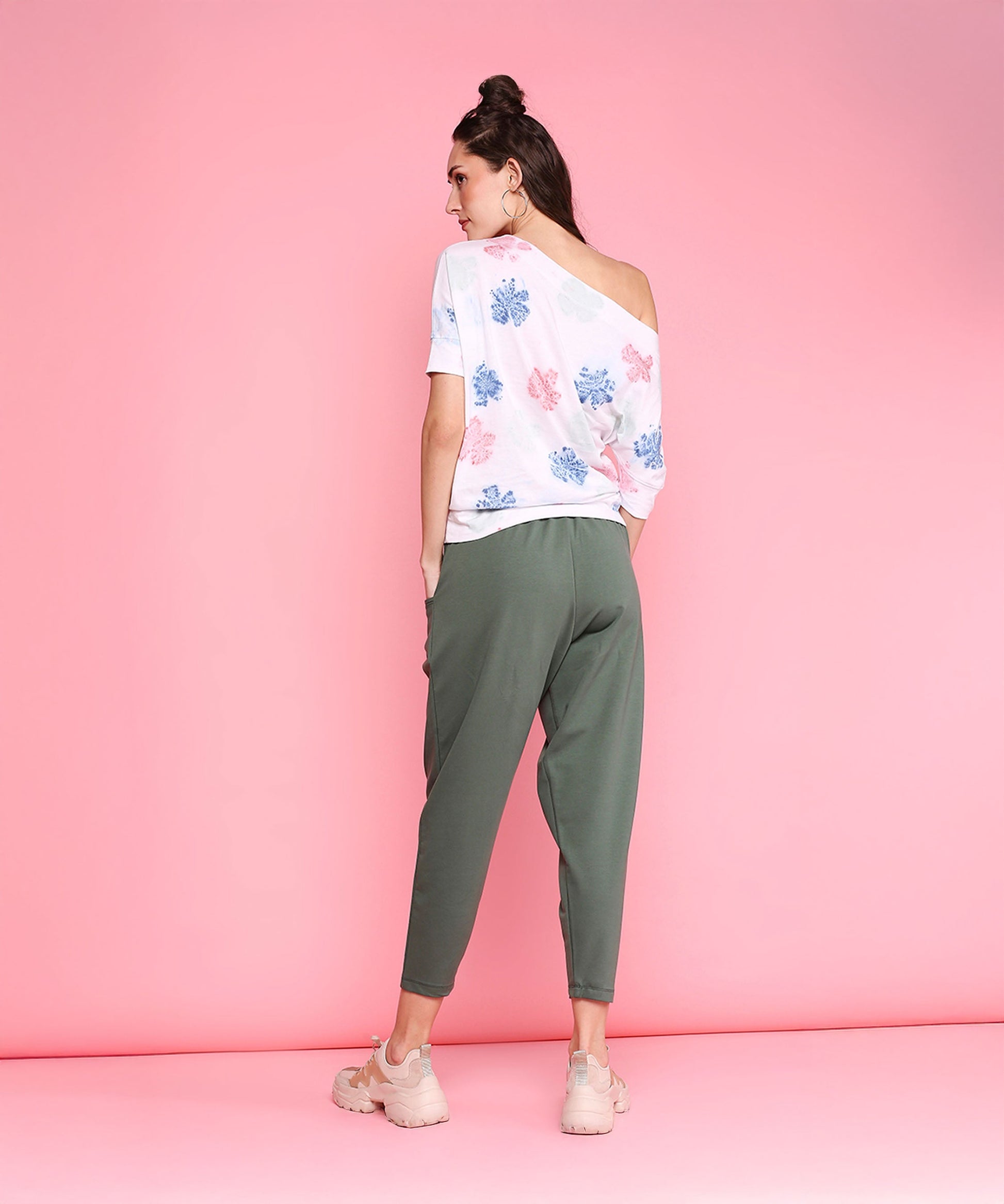 Model wearing comfortable yoga pants with pockets in olive green paired with a stylish top