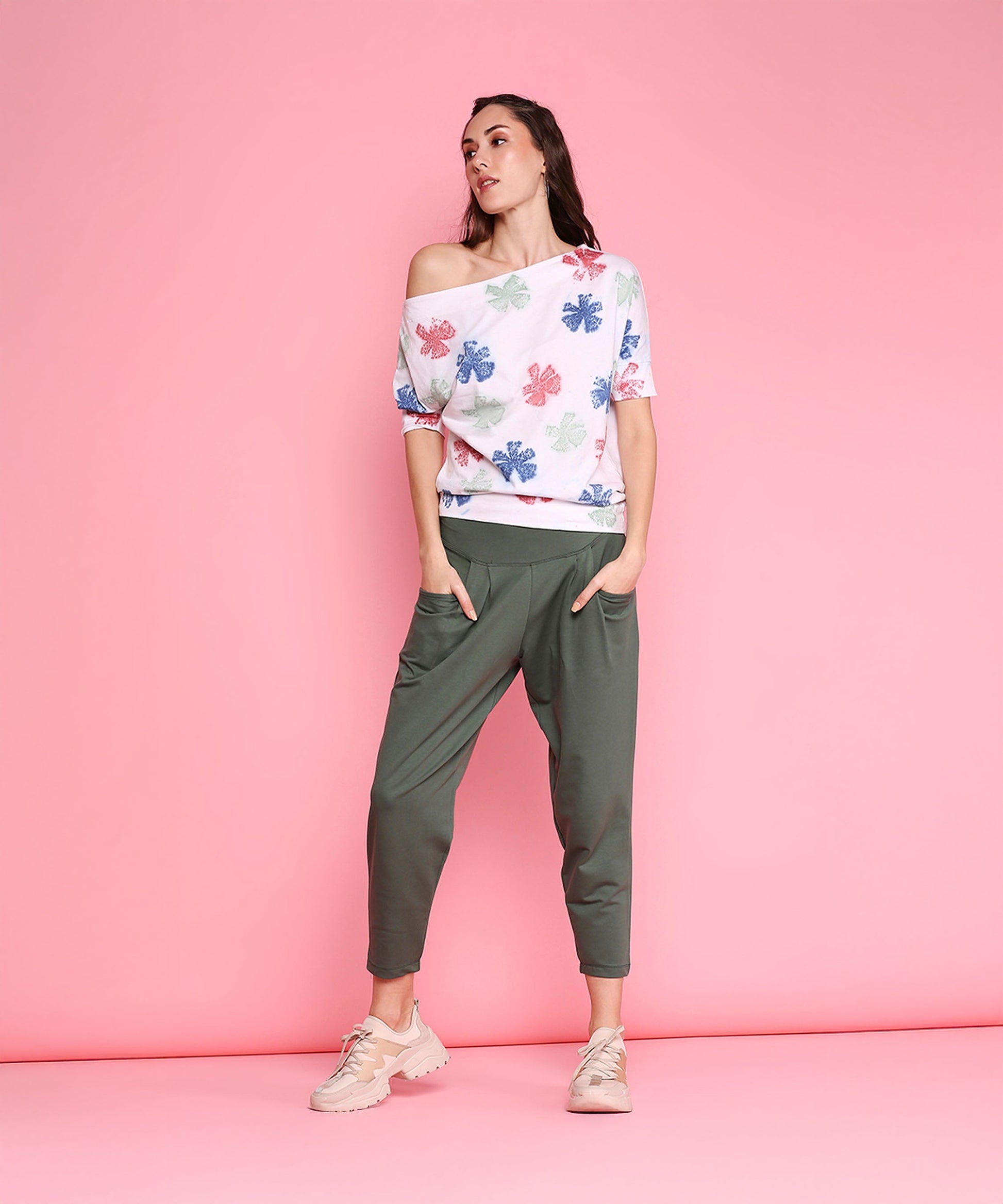 Stylish green comfortable yoga pants with pockets paired with a floral off-the-shoulder top