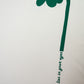 Cream oversized flower t-shirt featuring a large green flower design and the text kindness lies in your eyes