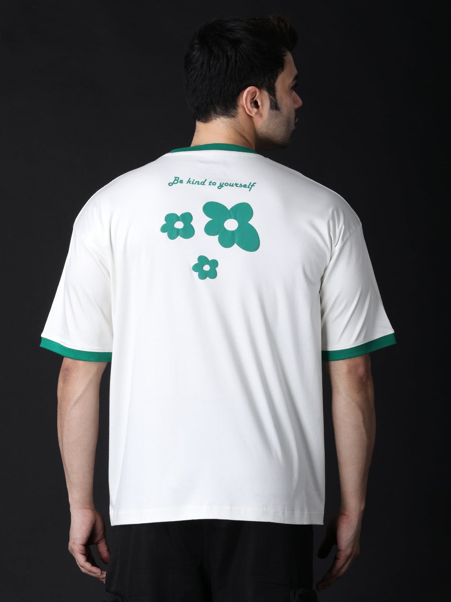 Cream oversized flower t-shirt featuring green flower graphics on the back for a trendy look