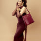 Stylish crimson bucket bag for women paired with elegant evening attire for a chic look