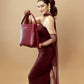 Stylish model holding a crimson bucket bag for women, perfect for chic outings or casual wear