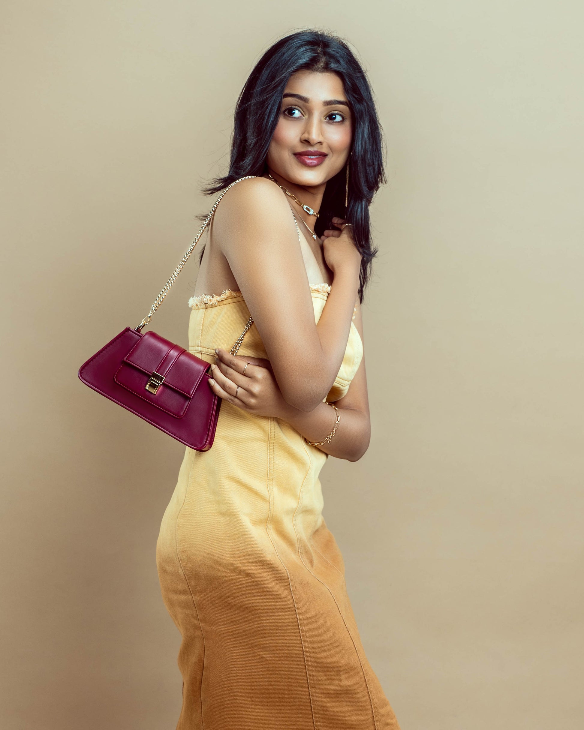 Stylish model showcasing a crimson mini baguette bag for trendy looks and versatile outfits