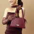 Elegant model showcasing a crimson small handbag with stylish design and premium finish