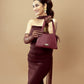 Elegant model holding a crimson small handbag from Stylera for stylish outings