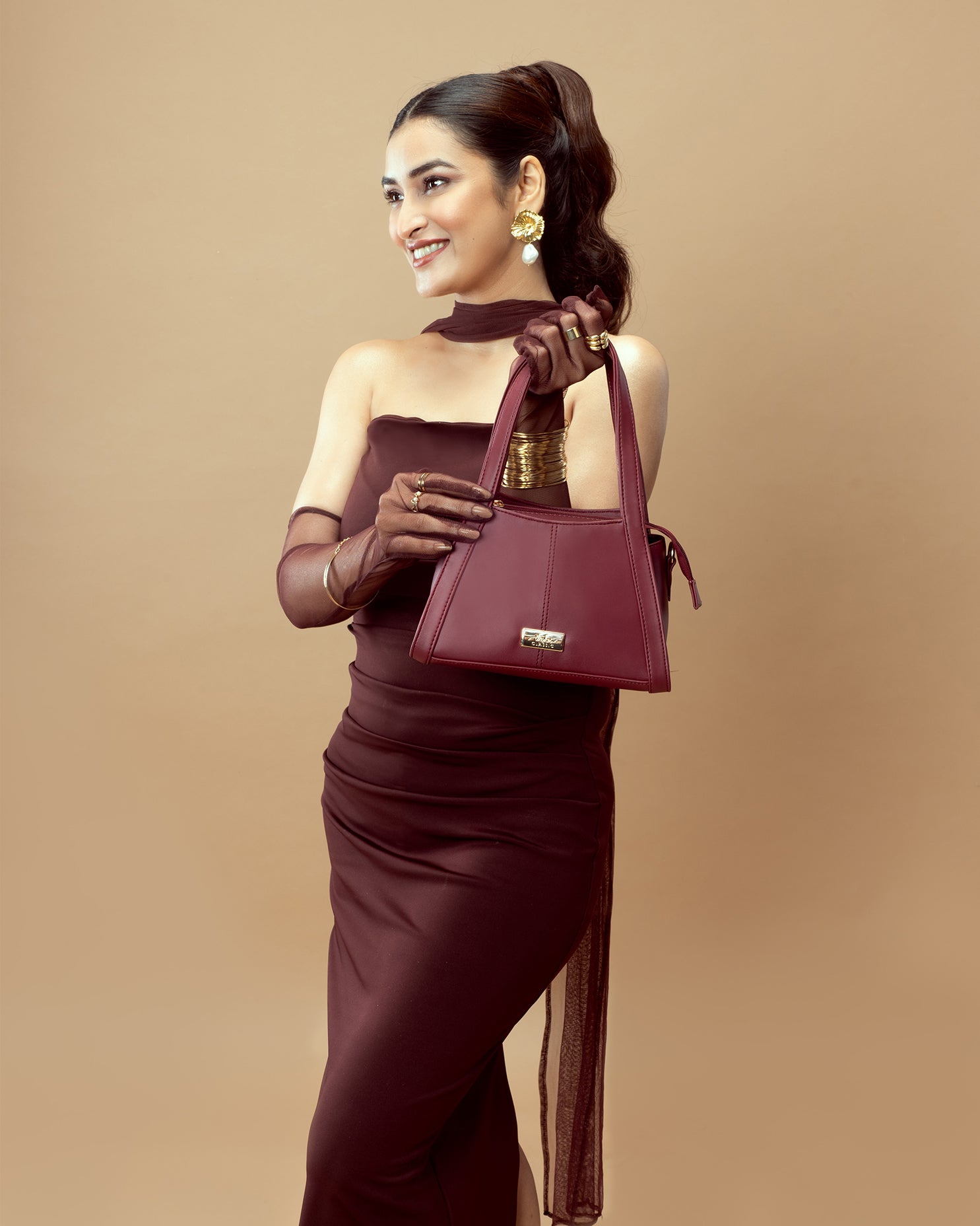 Elegant model holding a crimson small handbag from Stylera for stylish outings
